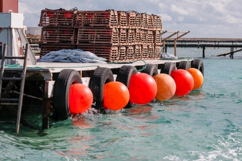 Horizontal shot of commercial cray fishing equipment on a jetty - Australian Stock Image