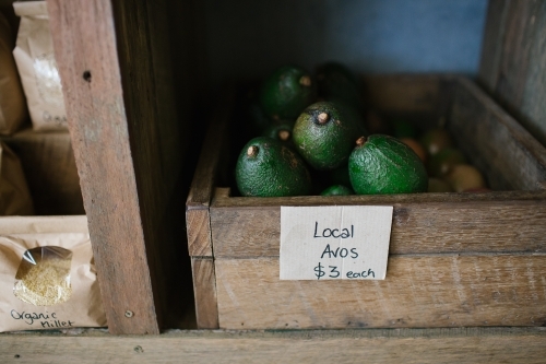 Horizontal shot of local avocadoes in a crate,