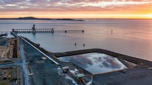 Horizontal shot of product piles in Barney Point, Gladstone, Queensland at sunset - Australian Stock Image