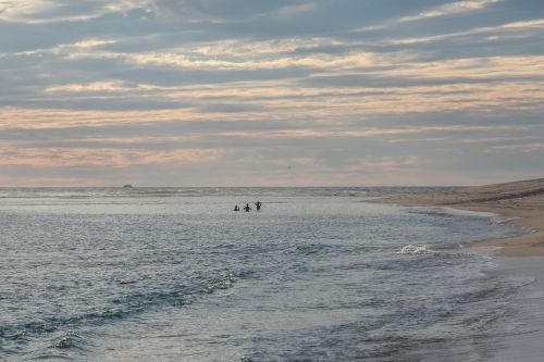 Horizontal shot of sea shore at sunset. - Australian Stock Image