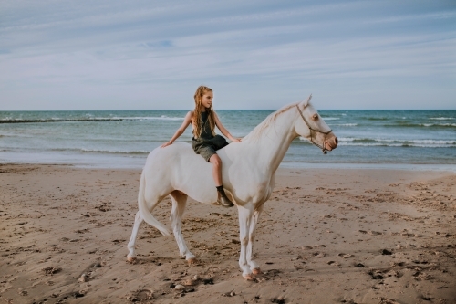 Horse riding on beach - Australian Stock Image