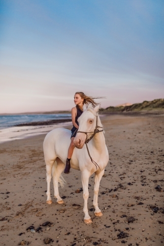 Horse riding on beach - Australian Stock Image