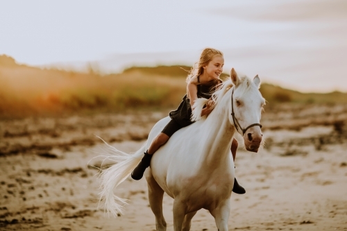 Horse riding on beach - Australian Stock Image
