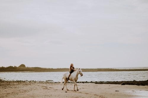 Horse riding on beach - Australian Stock Image