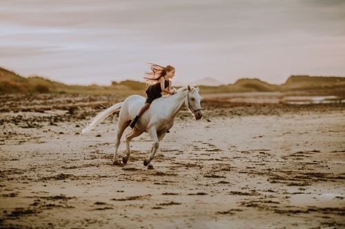 Horse riding on beach - Australian Stock Image