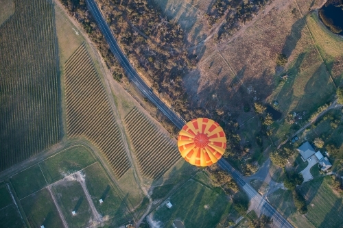 Hot air balloon appears to be travelling on road. - Australian Stock Image