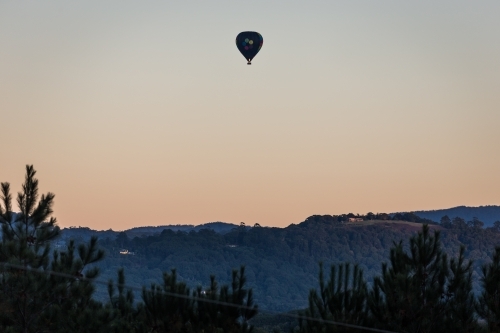 Hot air balloon flying in the early morning - Australian Stock Image