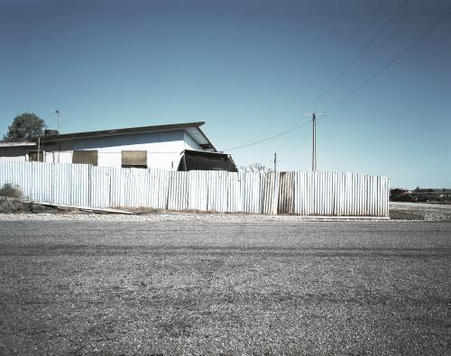 House with metal fence in outback town