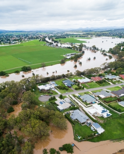 Hunter river in flood overflowing into backyards of homes