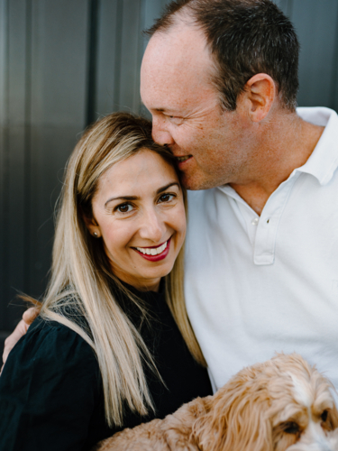 Husband giving a kiss on his wife's forehead. - Australian Stock Image