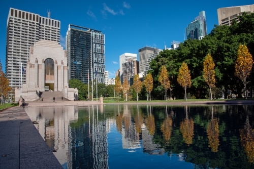 Hyde Park and Anzac Memorial with reflections of trees in water - Australian Stock Image