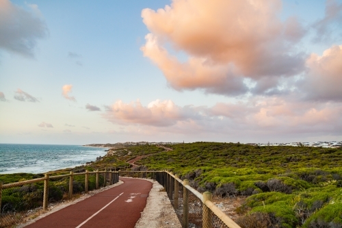 Iluka coastal walk at sunset, walking path between natural coastal vegetation - Australian Stock Image
