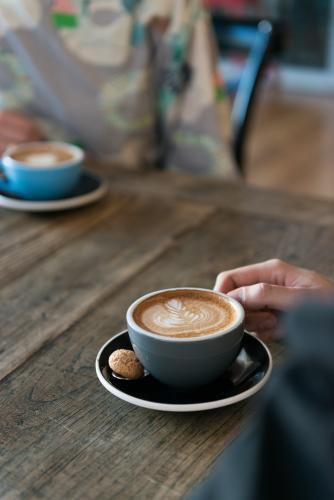 Image of a coffee on a wooden table - Australian Stock Image