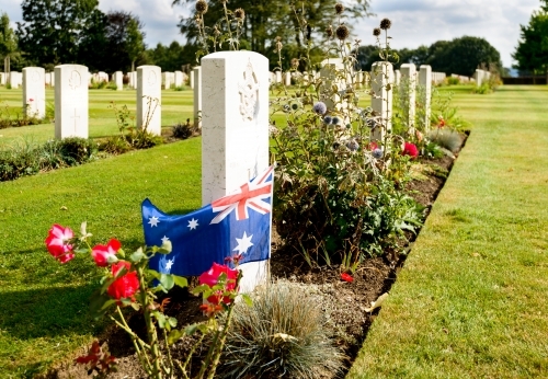 Image of a lone Australian flag on a war grave in Europe - Australian Stock Image
