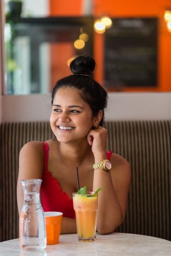 indian woman in a cafe - Australian Stock Image