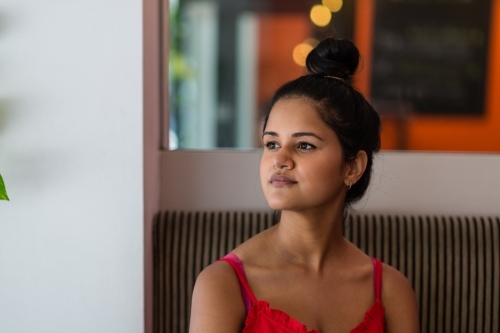 Indian woman in cafe - Australian Stock Image