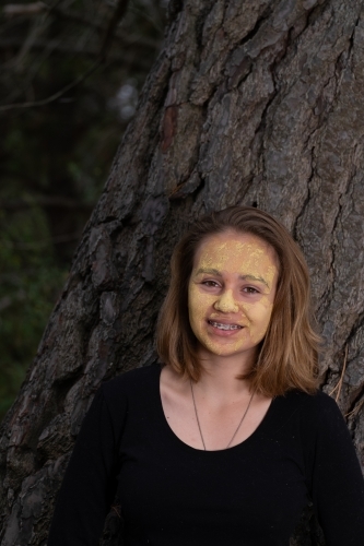 Indigenous girl near an old tree - Australian Stock Image