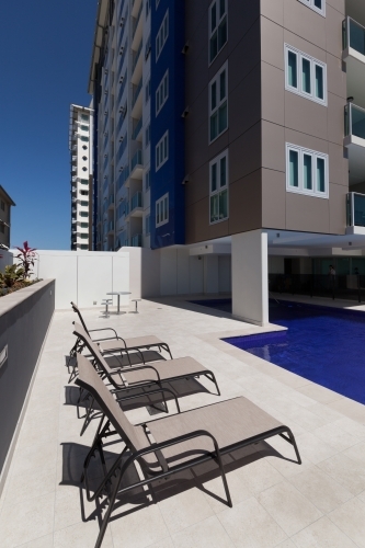 Inner city building with pool and sun lounges - Australian Stock Image