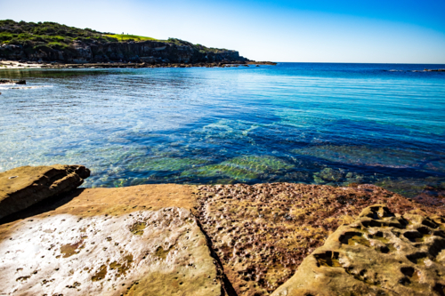 interesting rock formations at Little Bay beach - Australian Stock Image