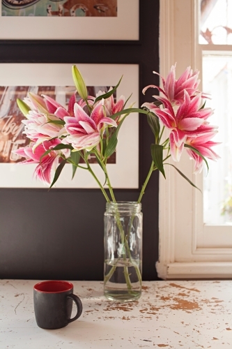 Interior vignette of flowers and coffee mug - Australian Stock Image