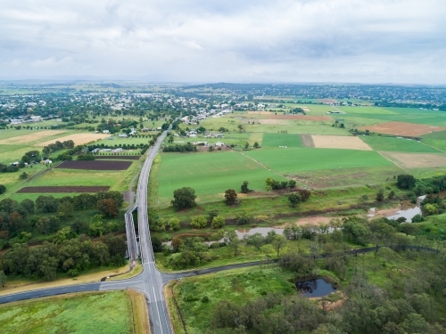 Intersection of country roads going to bridge towards town of Singleton - Australian Stock Image