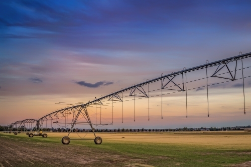 Irrigation machinery in paddock at dusk