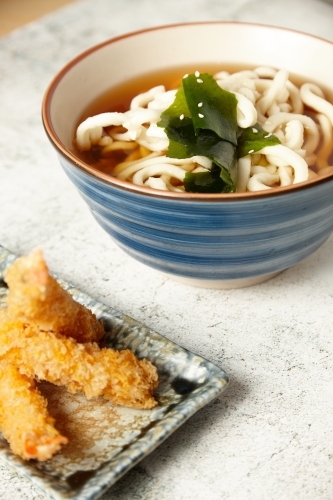 Japanese noodle with seaweed and shrimp tempura on the side - Australian Stock Image