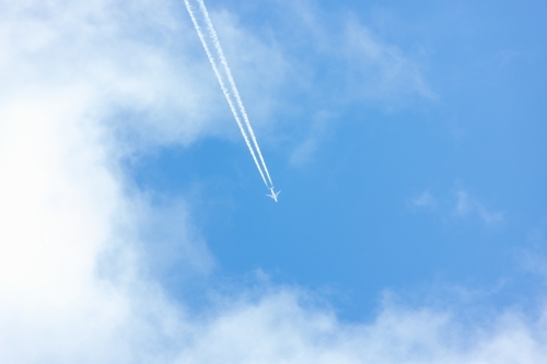 jet and contrails against blue sky
