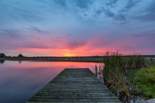 Jetty leading to colourful sunrise - Australian Stock Image