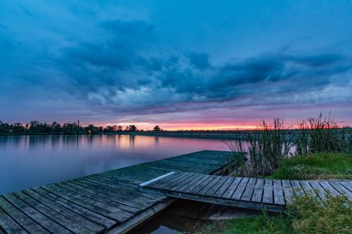 Jetty leading to colourful sunrise - Australian Stock Image