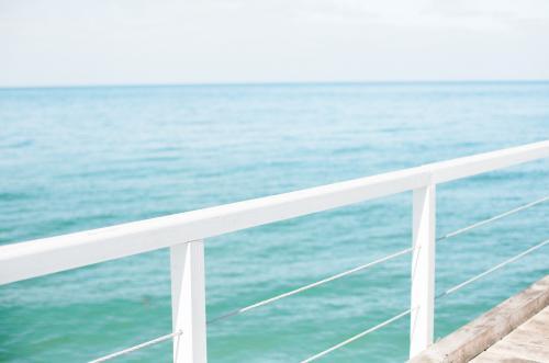 Jetty railing overlooking the ocean - Australian Stock Image