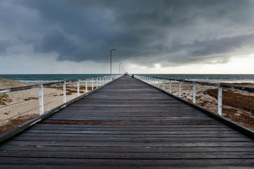 jetty under a stormy sky