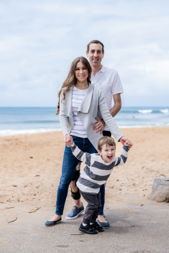 joyful family portrait at the beach - Australian Stock Image