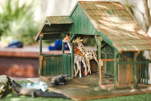 Jungle animal toy set in garden play space at kindergarten - Australian Stock Image