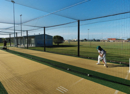 Junior cricketer standing ready during outdoor practice session - Australian Stock Image