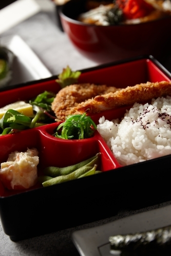 Katsu bento box with rice, meat, and vegetables - Australian Stock Image