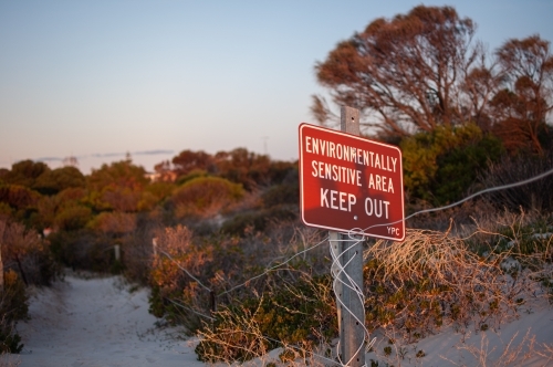 Keep out sign on sand dunes and coastal habitat
