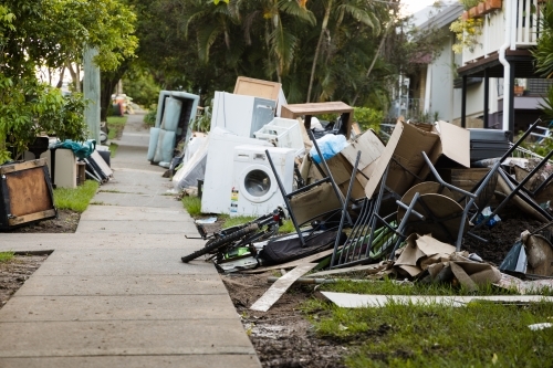Kerbside rubbish and waste waiting for collection after major flooding - Australian Stock Image