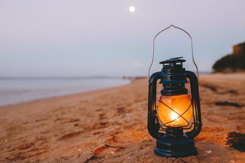 Kerosene lamp on the beach at dusk - Australian Stock Image