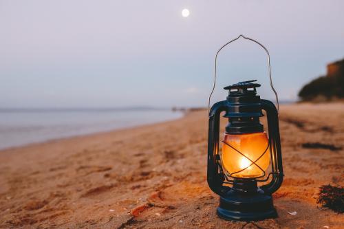 Kerosene lamp on the beach at dusk