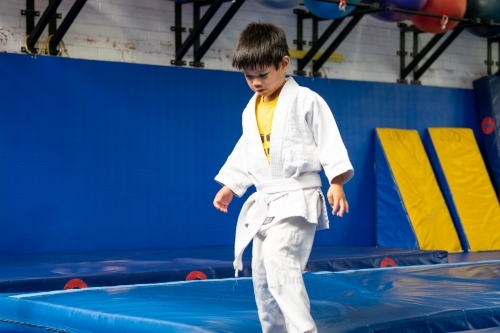 kid learning judo in a training gym - Australian Stock Image