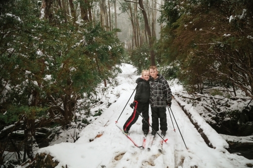 Kids cross-country snow skiing in Victoria's high country in winter - Australian Stock Image