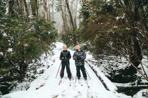 Kids cross-country snow skiing in Victoria's high country in winter - Australian Stock Image