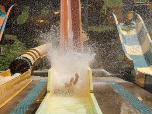 Kids having fun riding water slides on summer holiday in Coffs Harbour, Australia - Australian Stock Image