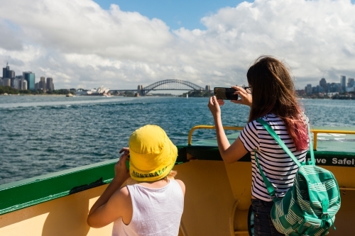 kids looking at the view of Sydney from the ferry - Australian Stock Image