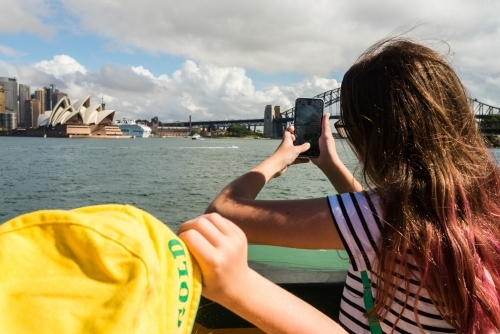 kids looking at the view of Sydney from the ferry - Australian Stock Image