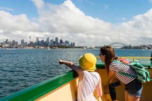 kids looking at the view of Sydney from the ferry - Australian Stock Image