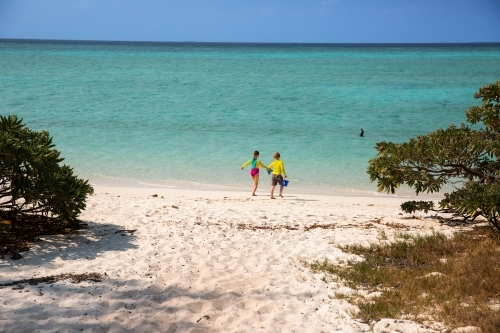 kids near the crystal clear water of the Great Barrier Reef on Heron Island - Australian Stock Image