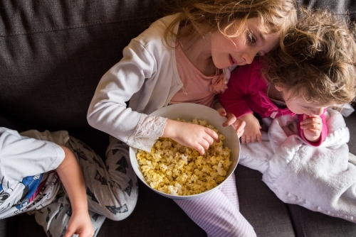 Kids watching movie at home - Australian Stock Image