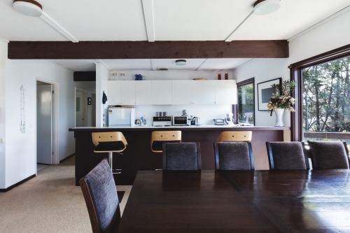Kitchen and dining area of older style retro funky Australian beach house - Australian Stock Image